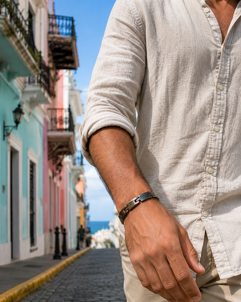 Person wearing a light-colored shirt with a colorful street in the background