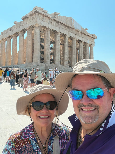 Dr. Irma Sierra and her husband smiling at the Parthenon in Athens, Greece, during their 40th anniversary trip across Europe