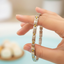 Silver with Gold link bracelet in hand with a blurred background