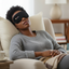 Woman wearing the Premium magnetic eye mask while taking a nap in a cozy living room setting