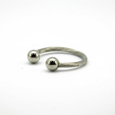 Silver ring with two spherical ends on a white background
