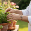 Older woman gardening herbs wearing delicate Ropei bracelet